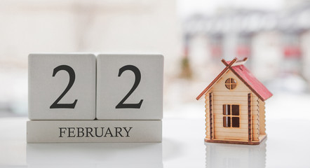 February calendar and toy home. Day 22 of month. Card message for print or remember