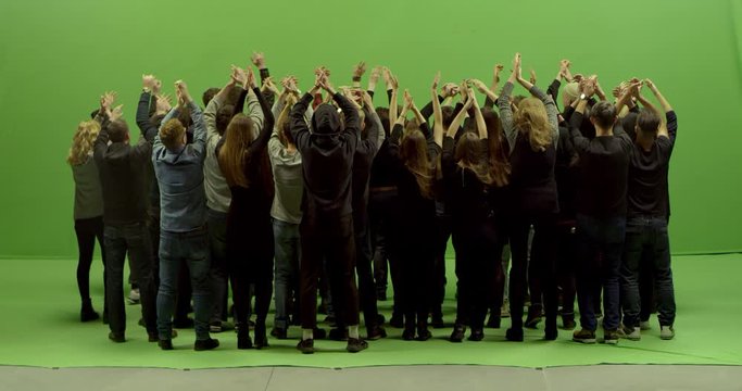 GREEN SCREEN CHROMA KEY Model released, back view of huge crowd clapping and cheering at a concert or a show. Shot on RED Helium 8K in RAW