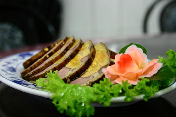 Close up shot of a plate of meat with thousand years egg