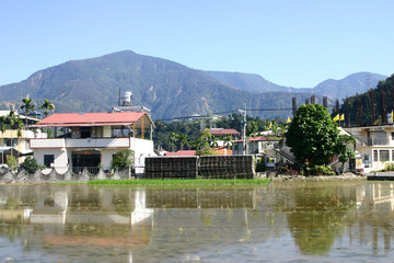 Sunny view of rural landscape with farm and building