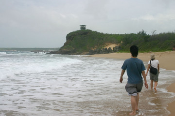 People walking on the beach in a strom day