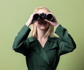 Style blonde woman with binoculars