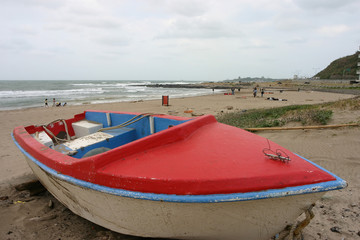Red small boat on the beach