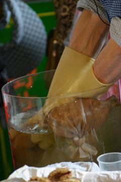 Worker making Aiyu jelly drinks with hands