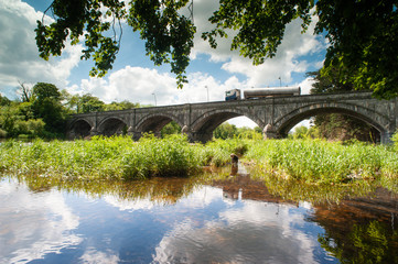 Fototapeta na wymiar Truck driving over old stone bridge in the town of Listowel, county Kerry