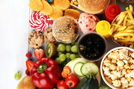 healthy or unhealthy food. Concept photo of healthy and unhealthy food. Fruits and vegetables vs donuts,sweets and burgers