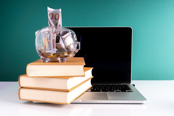 Laptop and book with educational concept.