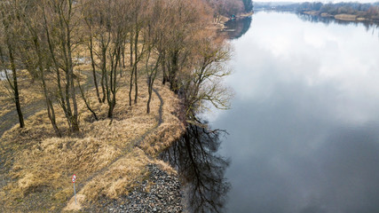 Aerial view of autumn river landscape in ocher. Brown, yellow and cold blue hues.