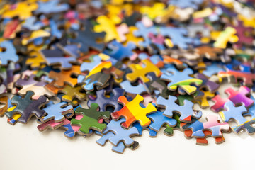 Pile of colourful jigsaw puzzle pieces on a table