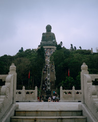 Hong Kong, China; Dic 1 2017: Tian Tan Buddha on Ngong Ping mountain with people walking down the stairs
