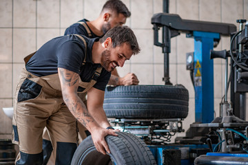 Fototapeta na wymiar Car mechanics working in auto repair service