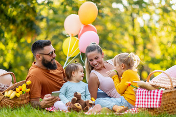 Cheerful family enjoying picnic in nature