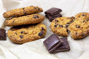 Freshly baked American chocolate chip cookies on rustic black metal table background