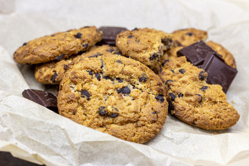 Freshly baked American chocolate chip cookies on rustic black metal table background