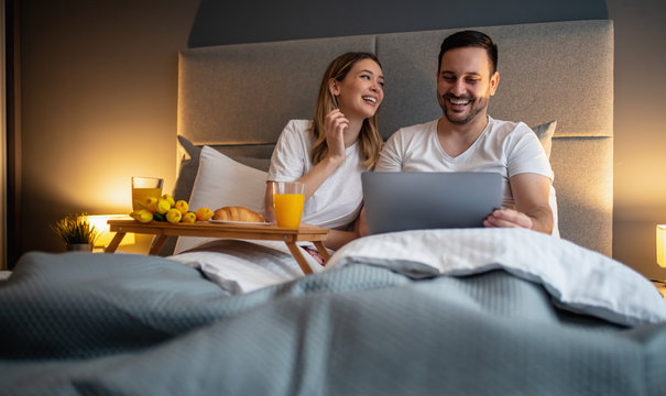 Portrait of happy couple in bedroom - Powered by Adobe