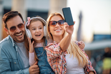 Family take selfie outdoors