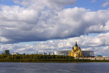 Obraz premium Nizhny Novgorod, Russia - September 15, 2019. View of the Alexander Nevsky Cathedral and the new stadium from the side of the Nizhny Novgorod Kremlin. Landscape with thunderclouds