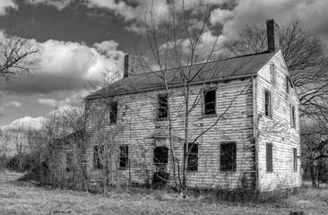 Black and white photograph of an abandoned haunted farm house of Six Mile Run, New Jersey.