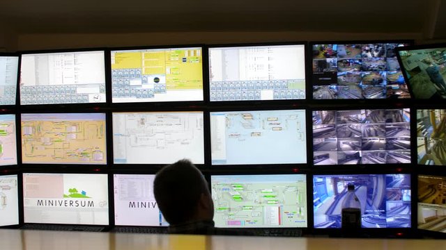 HUNGARY, BUDAPEST - MARCH 03, 2020: technician smoothes in video monitoring monitors and sensors for converging equipment, trains and other equipment in a miniature museum