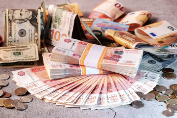 Large stack of banknotes, Russian rubles laying on a grey concrete surface