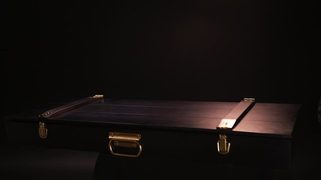 Close up of ancient valuable sward lying inside of wooden case with gold clasps. Stock footage. Hands in leather gloves open beautiful case with the antique exhibit, steel sabre inside.