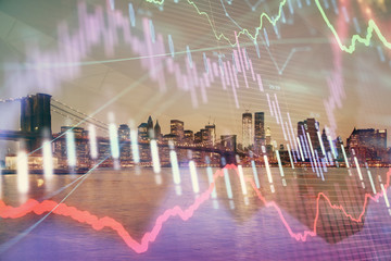 Financial graph on night city scape with tall buildings background double exposure. Analysis concept.