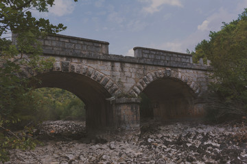 Old stone bridge and dry riverbed in hot summer. Knin in Croatia.