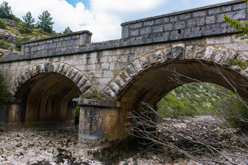 Old stone bridge and dry riverbed in hot summer. Knin in Croatia.