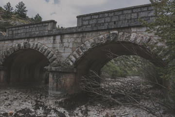 Fototapeta premium Old stone bridge and dry riverbed in hot summer. Knin in Croatia.
