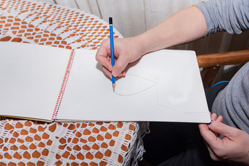 Man drawing with a pencil.