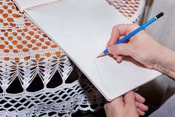 Man drawing with a pencil.