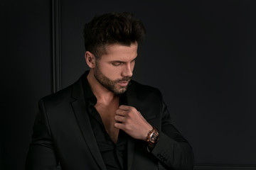 Man in elegant black suit posing