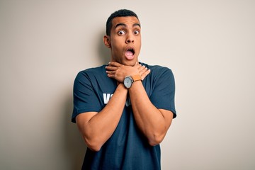 Young handsome african american man volunteering wearing t-shirt with volunteer message shouting and suffocate because painful strangle. Health problem. Asphyxiate and suicide concept.