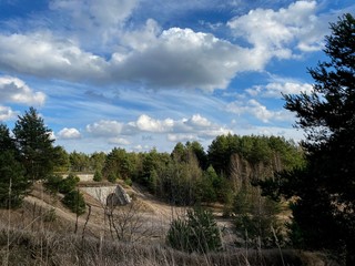 landscape with trees and blue sky, ruins of old fortifications in Poland