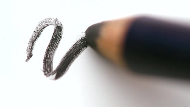 Black crayon eye liner pencil closeup. Make up over white. Cosmetic pencil and stroke isolated on white, draw. Texture of a makeup pencil. mark. traces of crayon. Slow motion 4K UHD video
