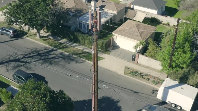 3G, 4G Cellular Tower in neighborhood of houses, aerial panning, in Los Angeles, California