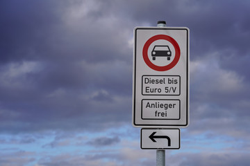 german street sign diesel driving ban in the downtown with a blurred background of clouds 