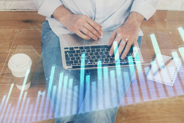 Forex graph with businessman working on computer in office on background. Concept of analysis....