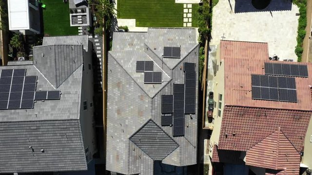 Aerial Top Down View Solar Panels on Rooftops in Residential Area, energy 