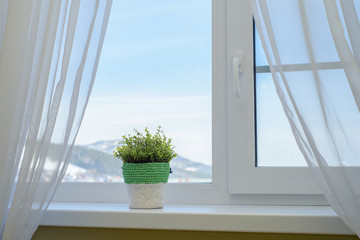 mountain view from the window with white curtains. Travel with comfort