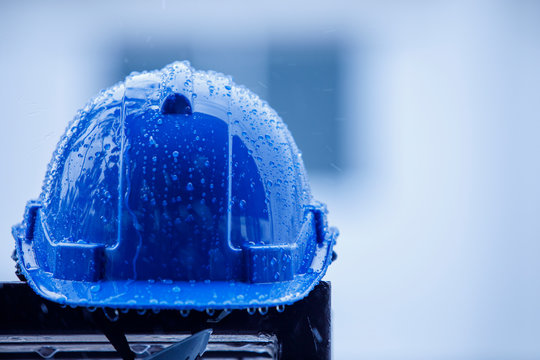 heavy rain and construction safety helmets, blue hard safety helmet and raining 