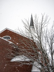 Snow falling on the church
