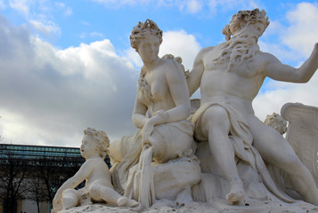 Sculpture in the central park of Paris with depicted people adults and children against the sky