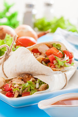 Mexican tacos with meat and vegetables in tortilla.
