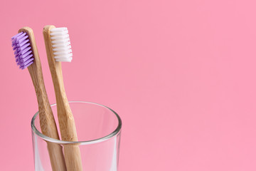 Two bamboo toothbrush close-up in glass on white background. Eco friendly and zero waste concept...