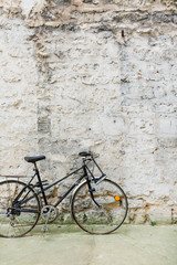 Old Bicycle Sitting Against a Stone Wall - 328209870