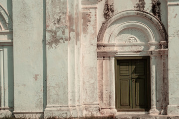 old green door with white building  abstract background