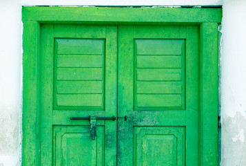 old green door with white building  abstract background
