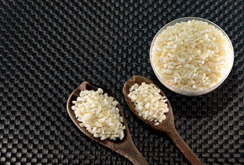 Hominy corn served in bowl and wooden spoons on a dark background