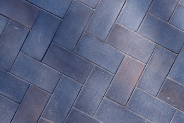 Blurred abstract background. Shadows from the trees fall on the surface of a blue brick. Beautiful abstract background. The texture of the blue wall with a geometric pattern. Textured Background.
